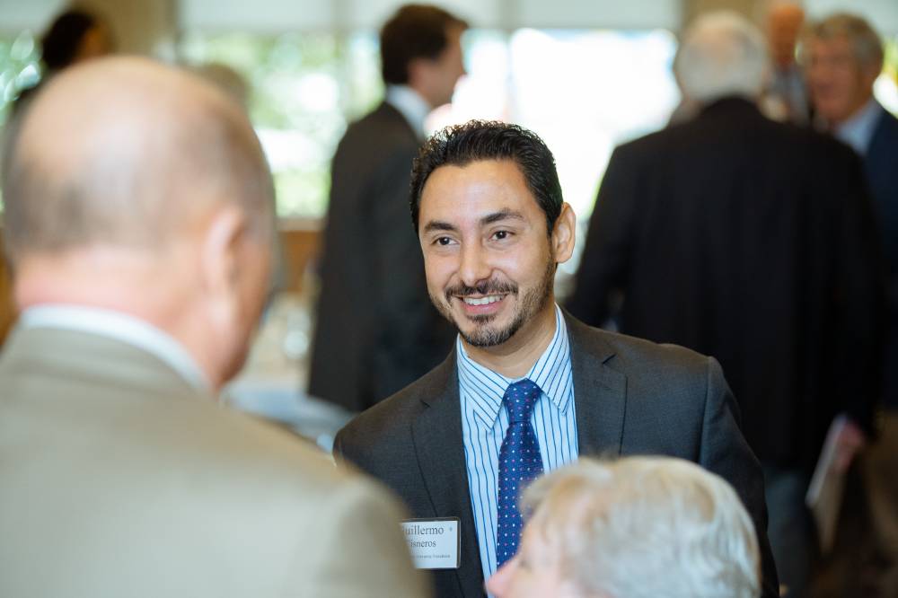 Guest smiling at another guest at the Foundation Annual Meeting